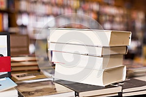 Stack of books lying on table in bookstore