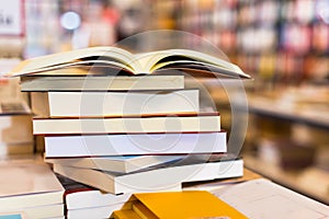 Stack of books lying on table in bookstore