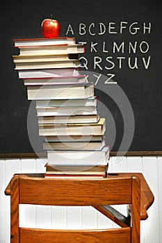Stack of books on an old school desk