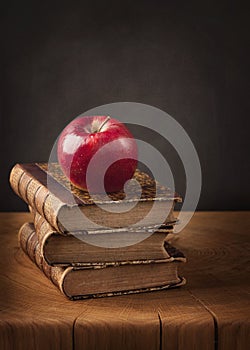 Stack of books and red apple