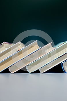 Stack of books in a row with on dark background