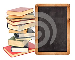 Stack of books with school blackboard