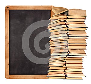 Stack of books with school blackboard