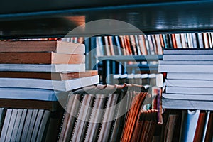 Stack of books on a shelf in the public library