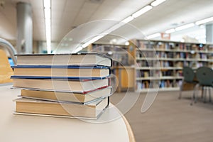 Stack of books on table at library