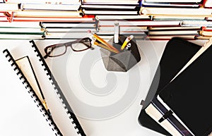 Stack of books, textbook, laptop, glasses in office business background for education learning concept