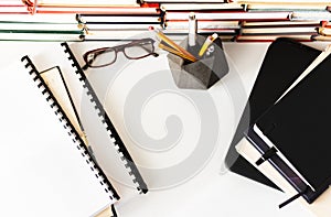 Stack of books, textbook, laptop, glasses in office business background for education learning concept