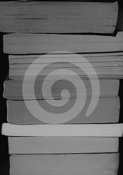 A stack of books with unique textures in black and white