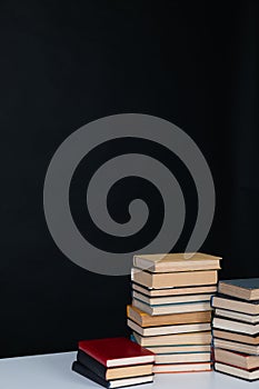 stack of books on a white table in the library on a black background