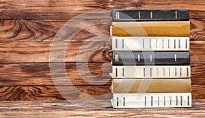 Stack of books on the wooden background