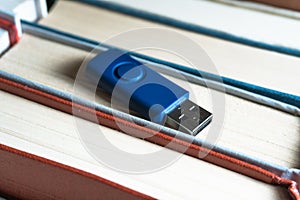 Stack books on wooden background. USB