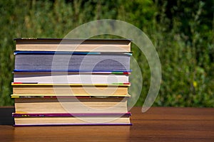 Stack of the books on wooden table outdoor
