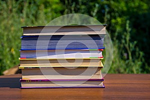 Stack of the books on wooden table outdoor