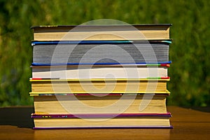 Stack of the books on wooden table outdoor
