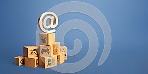 Stack of boxes and email internet symbol. Online Internet distribution of goods. E-commerce. Network marketing advertising. Remote