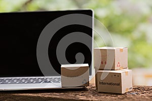 Stack boxes on laptop for Customer can buy from electronic internet.