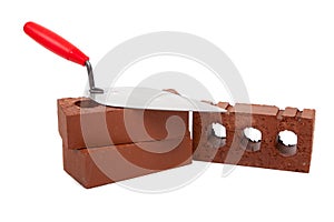 Stack bricks with trowel on a white background