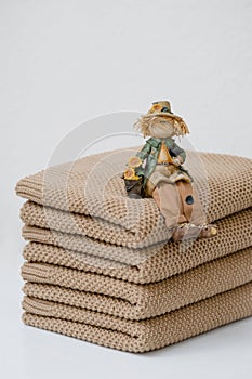 A stack of brown cotton plaids rests on a table. photo