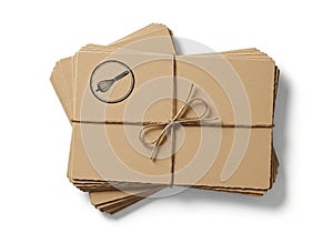 A stack of brown kraft paper cards tied with brown string,