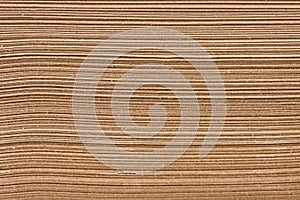 A stack of brown kraft paper sheets, close-up view