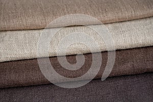 Stack of brown linen fabrics, close up