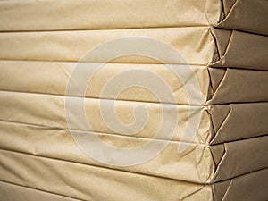 Stack of brown paper packaging. Side of corner of wrapping packaging