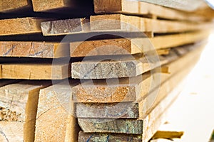 Stack of building lumber at construction site with narrow depth