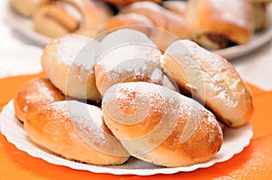 A stack of buns on a white plate