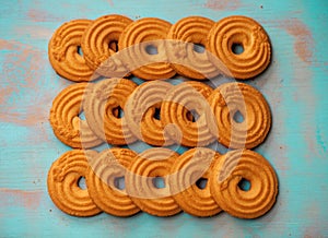 Stack of butter cookies/biscuits on wooden teal green rustic background, flat lay design with butter cookies photo