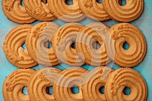 Stack of butter cookies/biscuits on wooden teal green rustic background, flat lay design with butter cookies photo