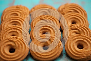 Stack of butter cookies/biscuits on wooden teal green rustic background photo