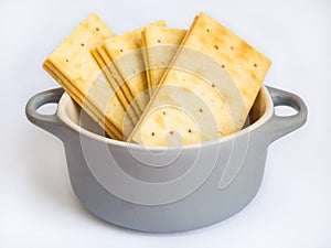 Stack of butter crackers on white background