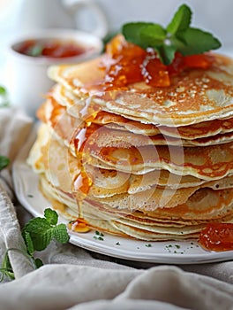 Stack of Buttermilk Pancakes with Apricot Jam and Fresh Fruit on Rustic Table