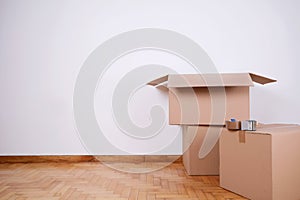 Stack of cardboard boxes in the empty room