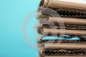 Stack of cardboard for recycling on color background, closeup.