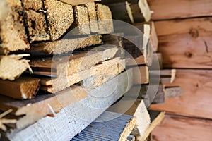 A stack of carpentery waste using as firewood, sustainable, rational and effective use of wood for heating house