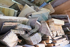 A stack of carpentery waste using as firewood, sustainable, rational and effective use of wood for heating house, low