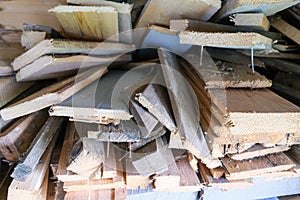 A stack of carpentery waste using as firewood, sustainable, rational and effective use of wood for heating house, low