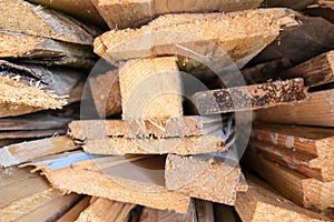 A stack of carpentery waste using as firewood, sustainable, rational and effective use of wood for heating house, low