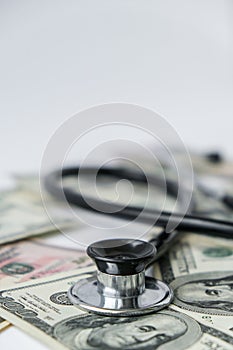 Stack of cash dollars and stethoscope. The concept of medical expensive medicine, doctors salary. Copy space for text