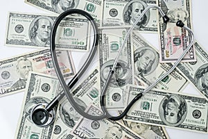 Stack of cash dollars and stethoscope. The concept of medical expensive medicine, doctors salary. Copy space for text