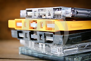 Stack Cassette tapes over wooden table. retro filter