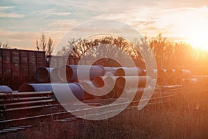 Stack of cast iron pipes in loading area waiting for transportation