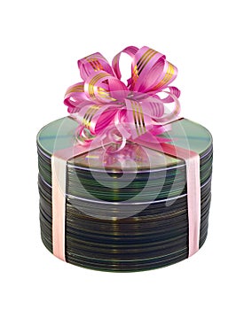 Stack of CD disks with gift lace over white