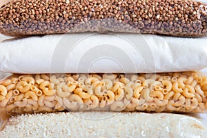 Stack of cereal and sugar products on a white background with place for text. Food supplies. Food supplies . Food delivery,
