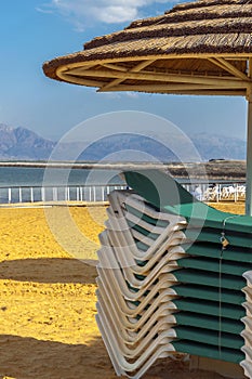 Stack of chaise lounges at the Dead sea beach