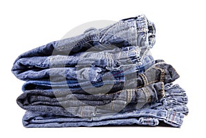 Stack of children's jeans isolated on white