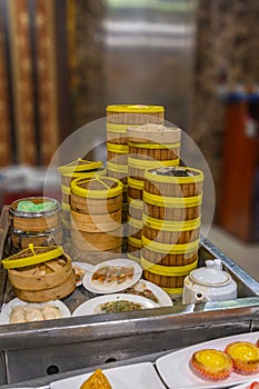 Stack of Chinese dimsum bamboo steamer boxes served in restaurant