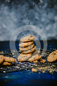 Stack of chocolate chip cookies on a blue textured table