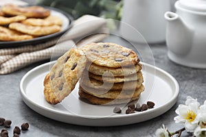 Stack of chocolate chip cookies. Dark background. Sweet delicious snack